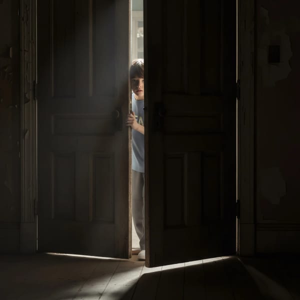 Boy standing in doorway