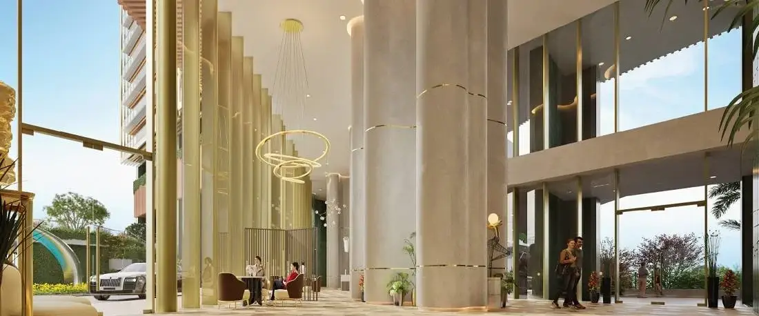 Modern lobby with tall columns, seating area, large windows, and decorative lighting.