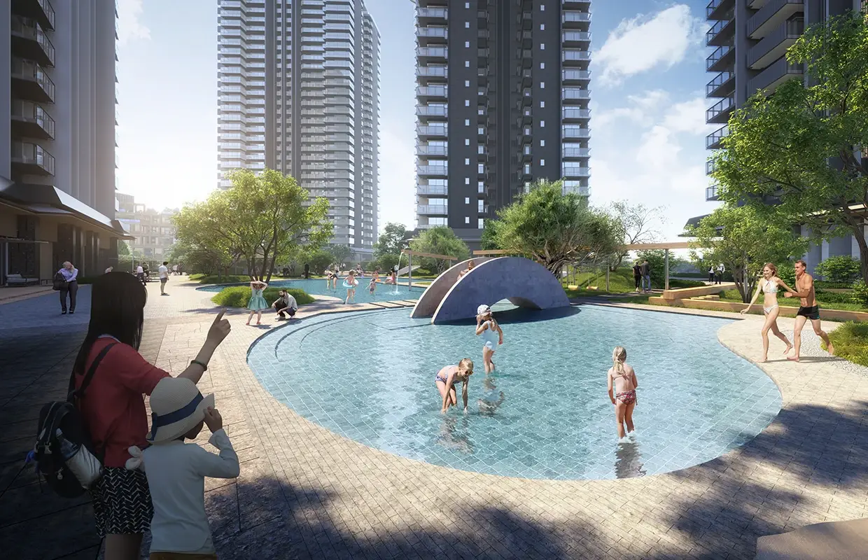 Children playing in a pool surrounded by modern buildings and greenery.