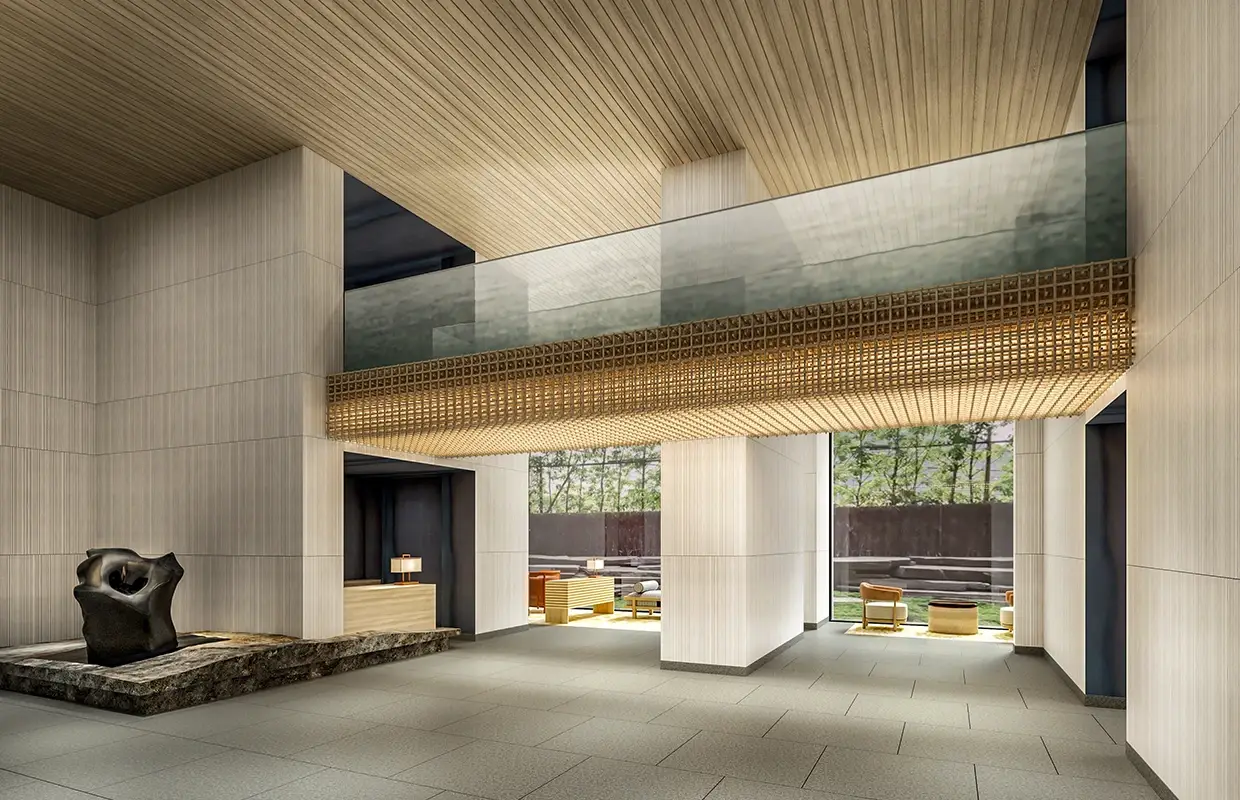 Modern lounge with wooden ceiling, stone sculpture, and glass balcony overlooking outdoor seating.