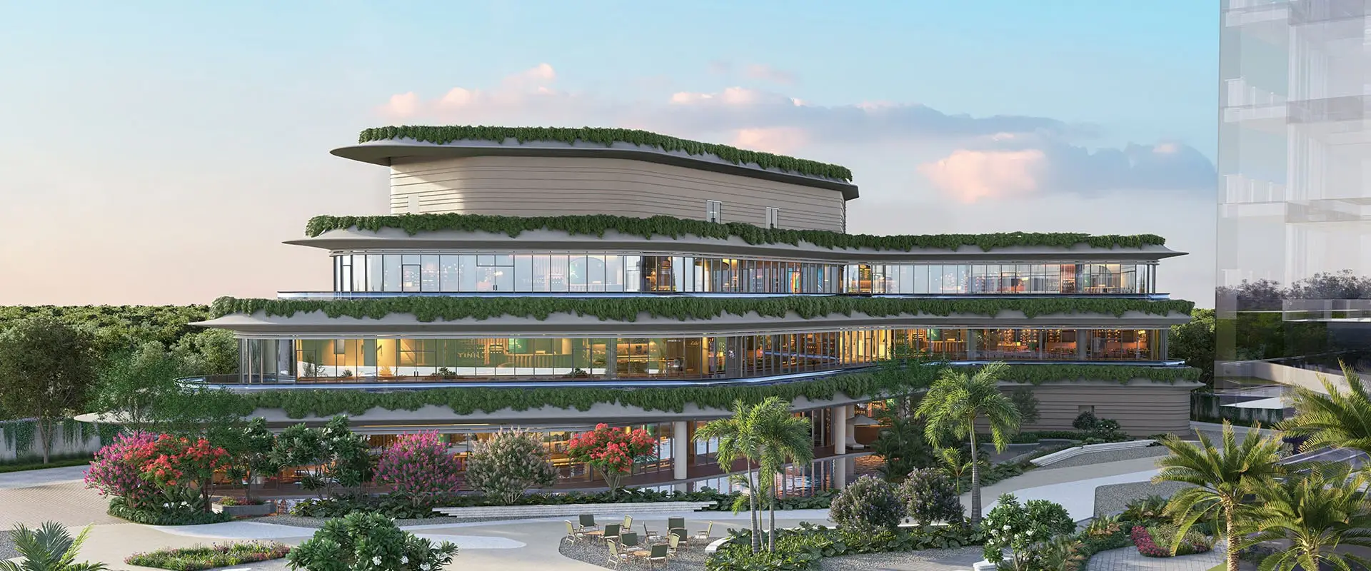 Modern three-story clubhouse with greenery, large windows, and surrounding landscaped gardens.