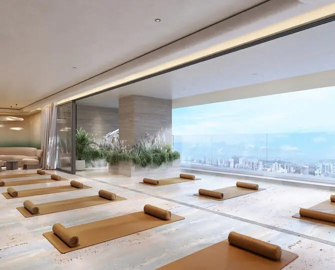 Spacious yoga studio with mats arranged, large windows showcasing city views and greenery.