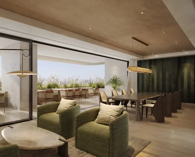 Modern co-working area featuring green chairs, a long dining table, and large glass doors.