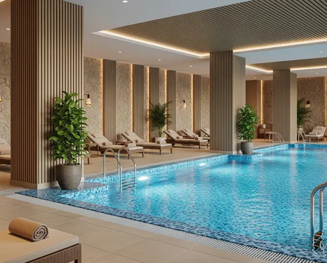 Luxurious indoor pool area with lounge chairs, plants, and decorative wall panels.