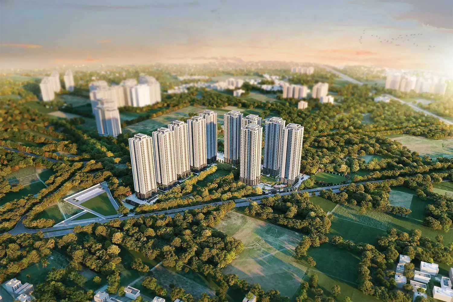 Aerial view of multiple tall residential towers surrounded by greenery and roads.