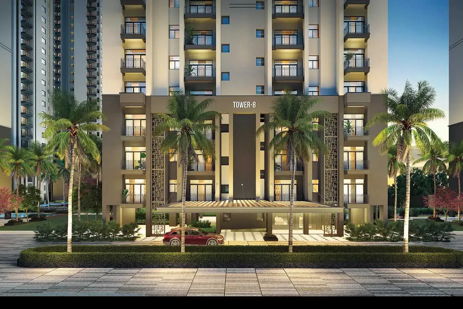 Modern residential building with palm trees and a car under a covered entrance.