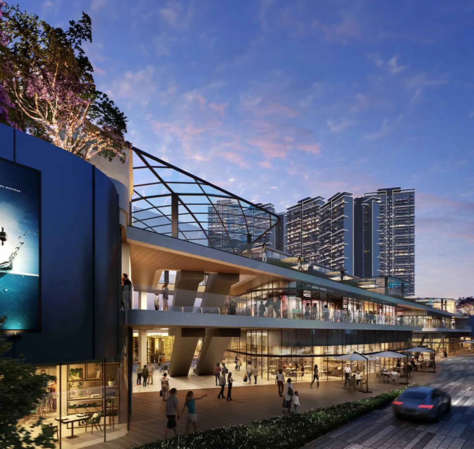 Modern shopping complex with glass roof, people walking, and tall buildings in the background.