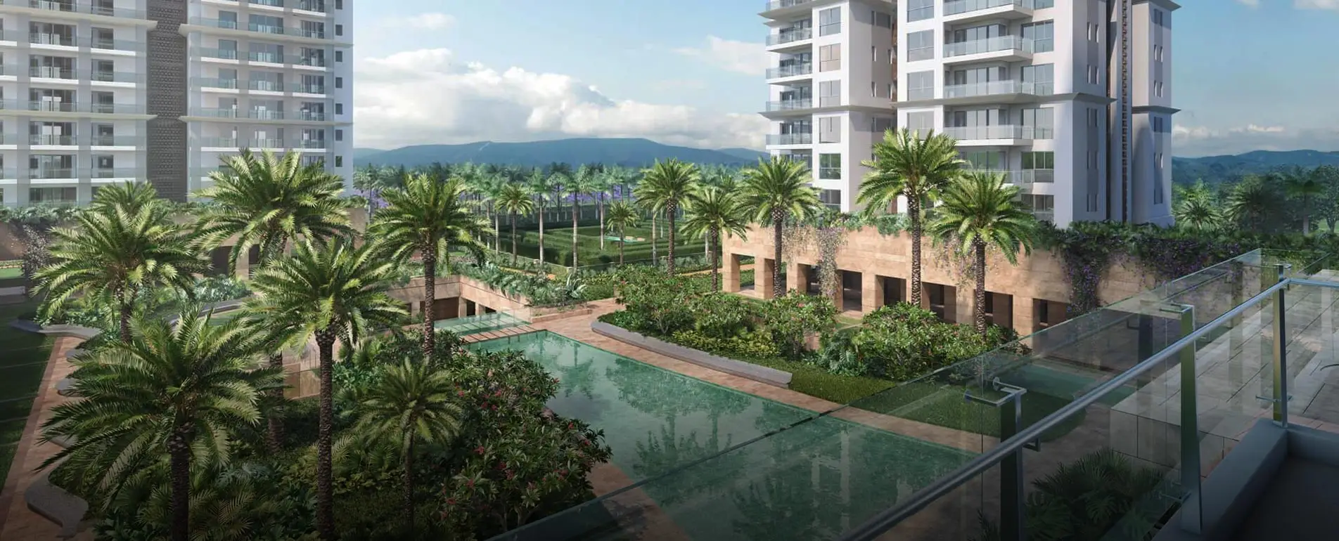 Modern residential buildings surrounded by palm trees and a reflective pool in a landscaped area