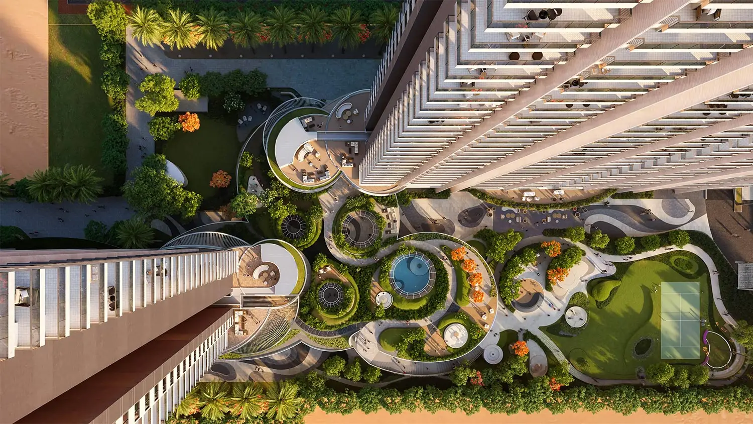 Aerial view of landscaped gardens and modern buildings with pools and seating areas.