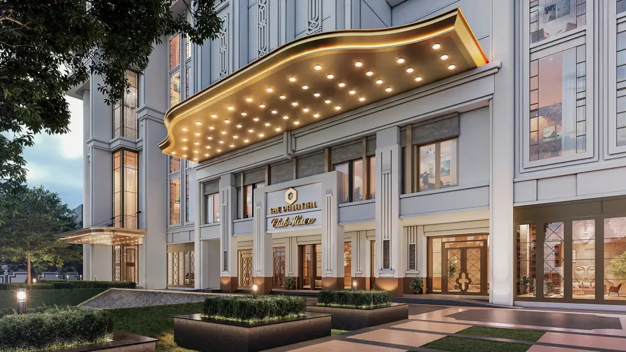 Elegant building entrance with a marquee, decorative lights, and landscaped surroundings.