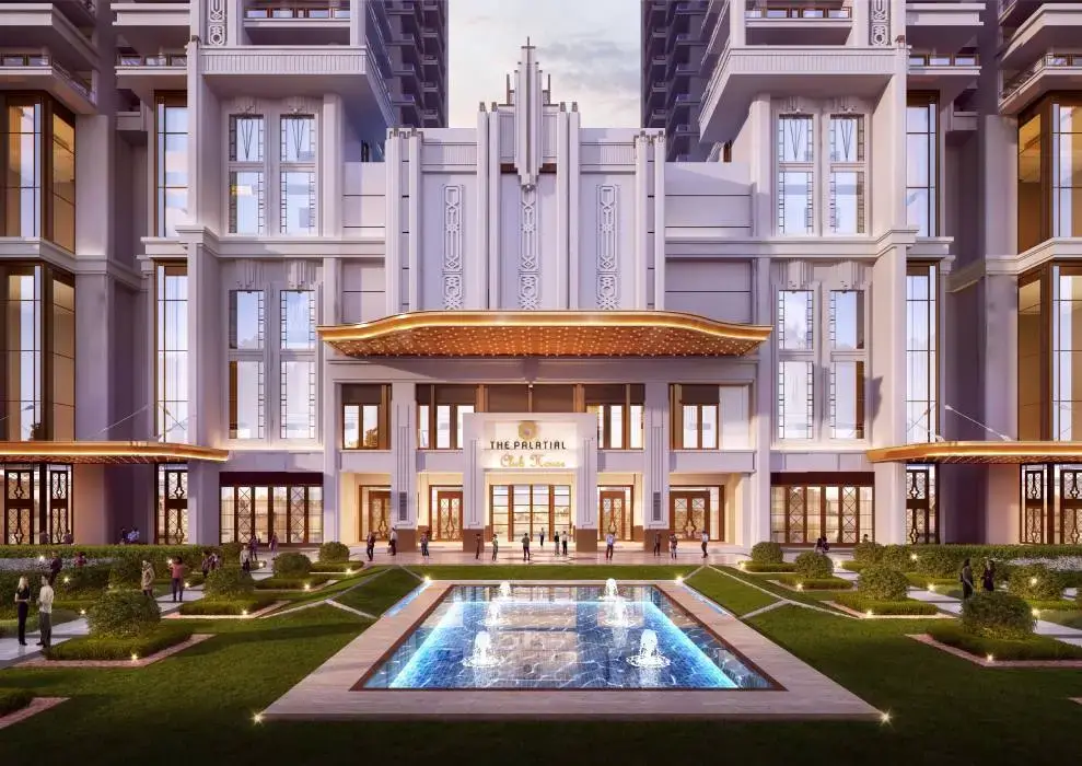 Grand building facade with ornate details, water fountain, and landscaped gardens in front.