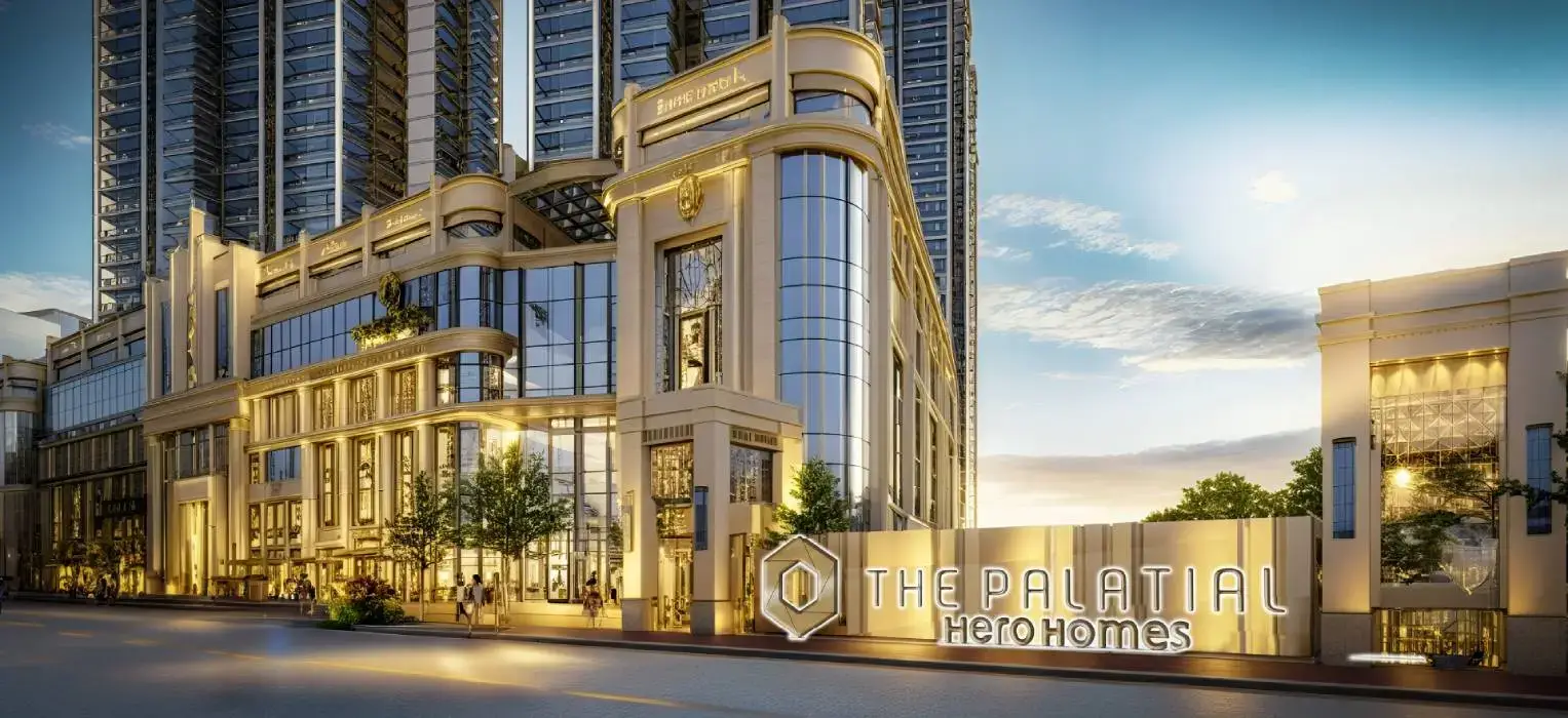 Modern building facade with large glass windows, decorative elements, and landscaped entrance.