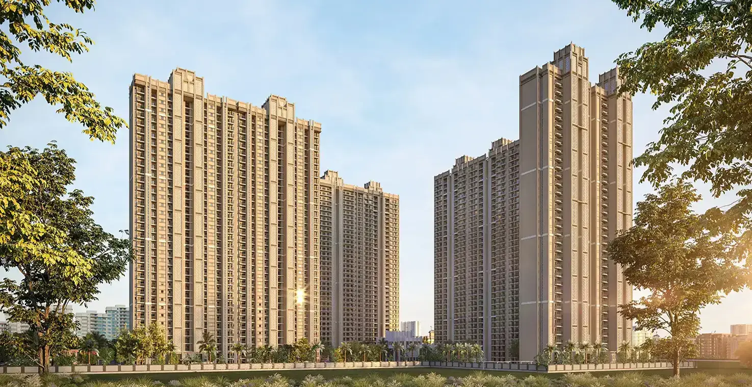 Two tall residential buildings surrounded by greenery and a clear blue sky.