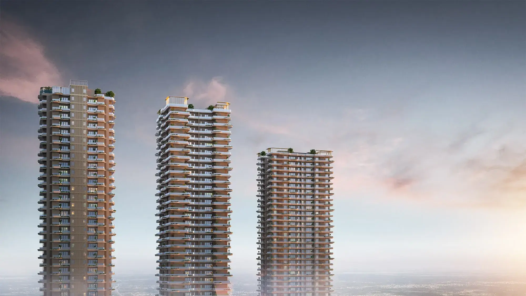 Three tall residential towers with balconies against a cloudy sky at sunset.