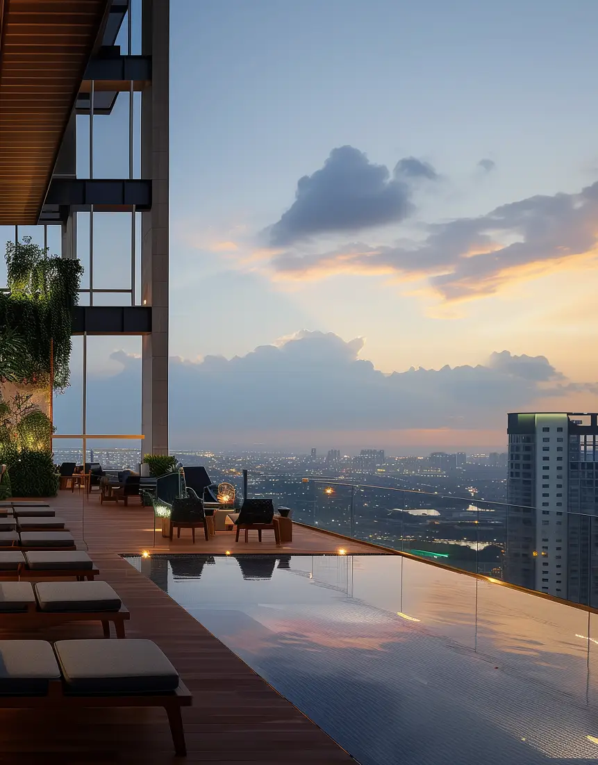 Rooftop infinity pool with lounge chairs, city skyline, and sunset clouds in the background.