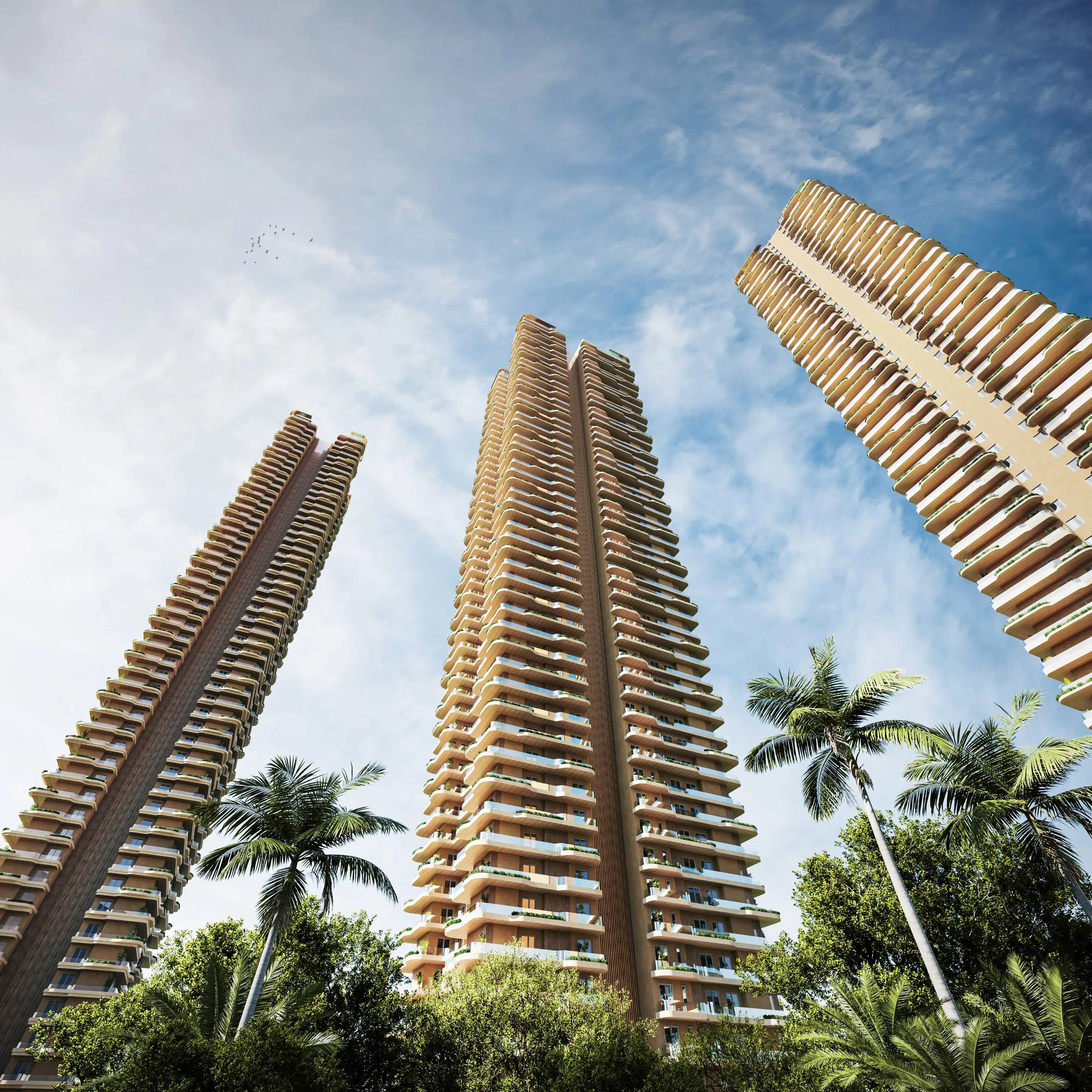 Three tall residential towers surrounded by lush greenery and palm trees under a clear blue sky.