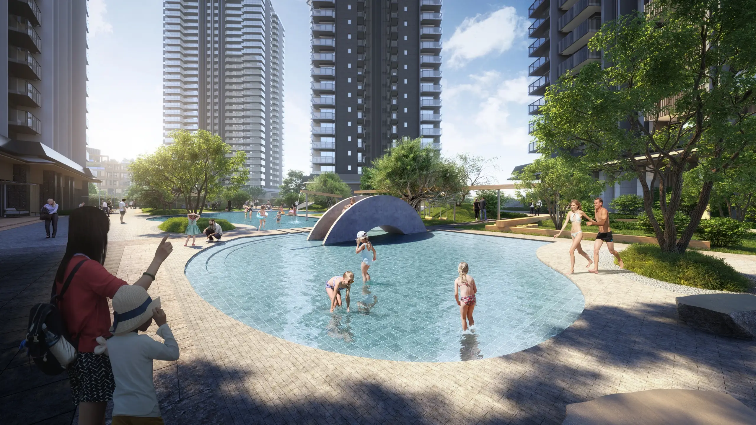 Children playing in a circular pool surrounded by greenery and modern buildings.