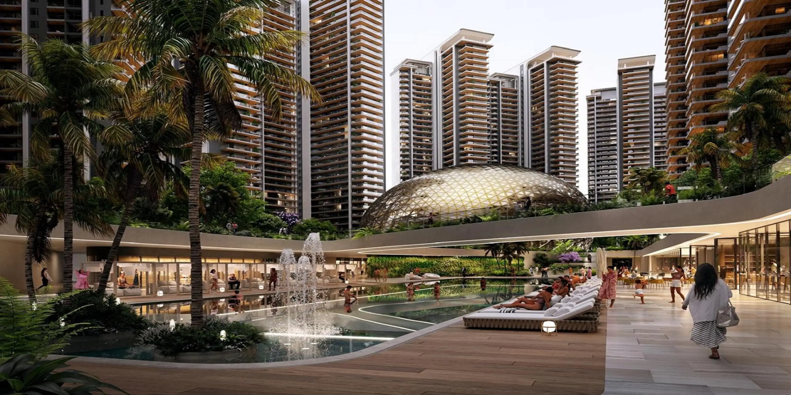 Modern residential complex with high-rise buildings, pool, fountain, and lush greenery.