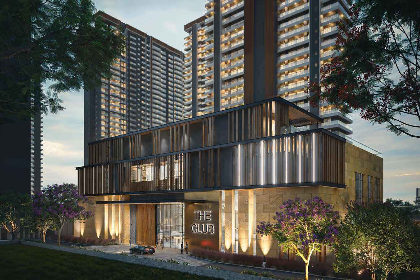 Modern club building with large glass windows, surrounded by trees and flowering plants.