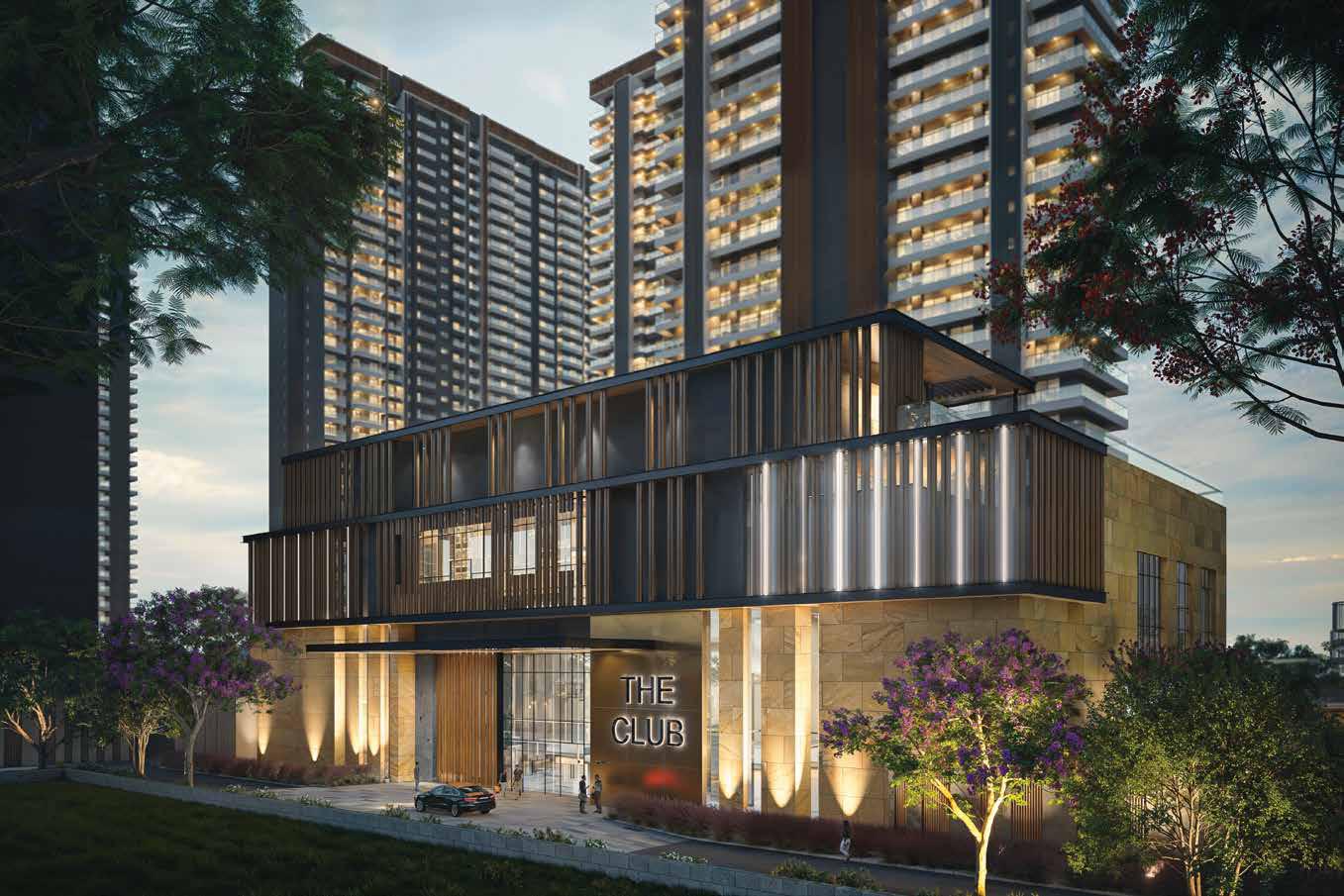 Modern building with large glass windows, surrounded by greenery and tall residential towers.