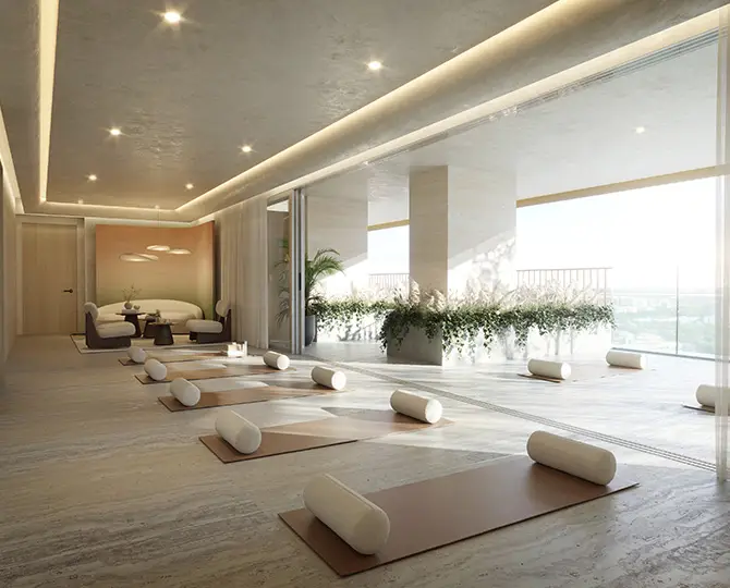 Bright yoga studio with mats and props, large windows, and plants for ambiance.