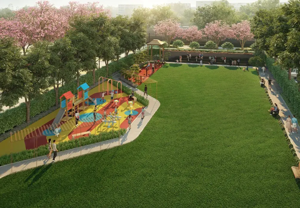 A vibrant playground with colorful equipment surrounded by green grass and blooming trees.