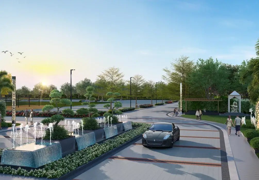 A landscaped entrance with fountains, trees, a black car, and pedestrians walking.