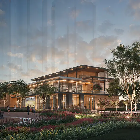 Modern building with large windows surrounded by landscaped gardens and people enjoying the space.