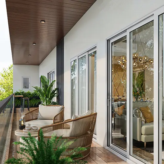 A modern balcony with two rattan chairs, a small table, and potted plants.