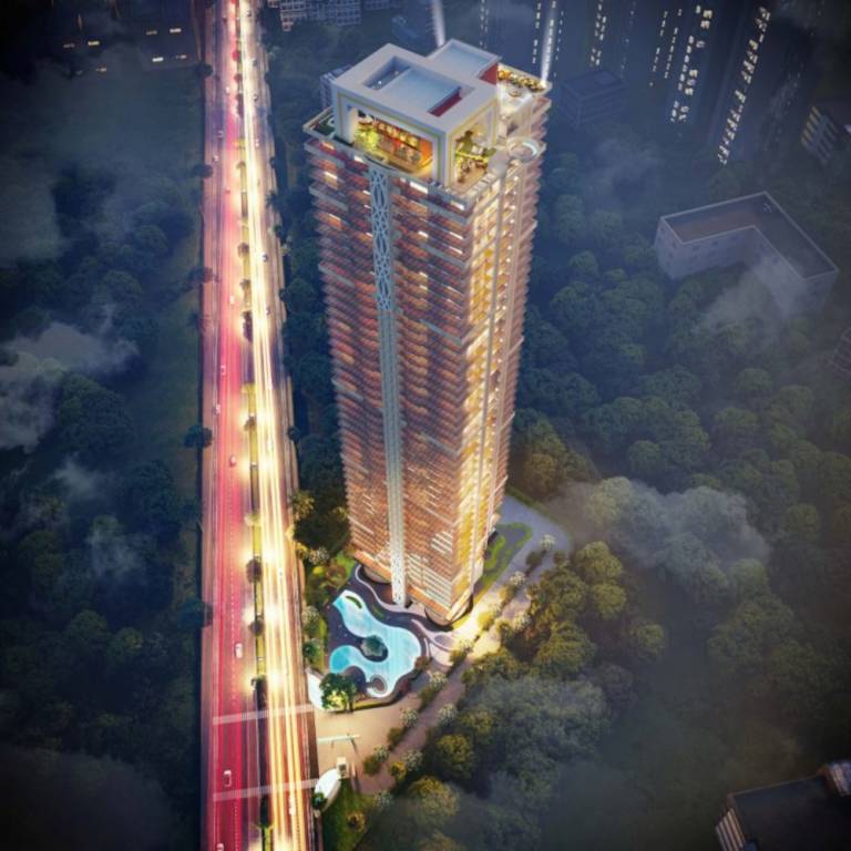 A tall residential building with illuminated balconies, surrounded by greenery and a swimming pool.