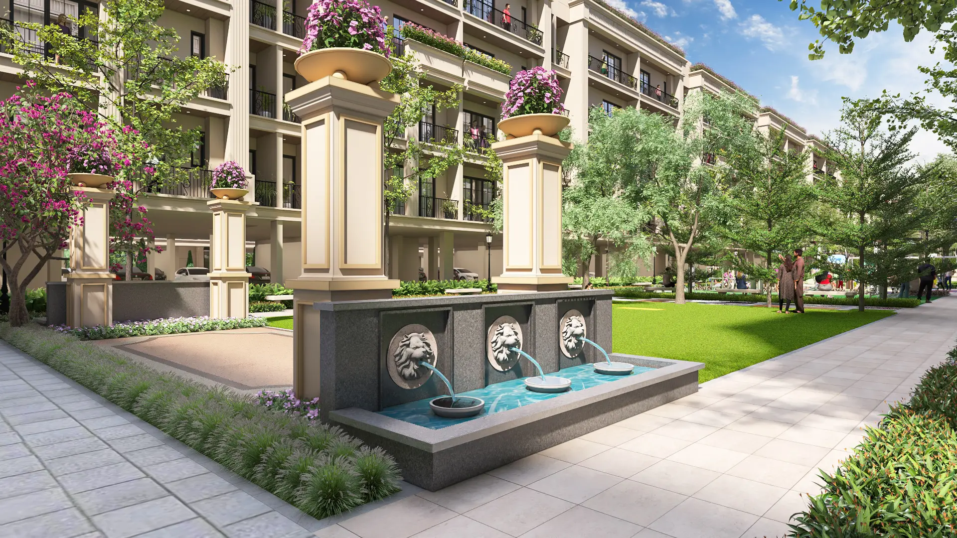 A decorative fountain with lion head spouts, surrounded by greenery and flower pots.