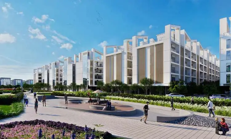 Modern residential buildings with greenery, pathways, and people enjoying the outdoor space.