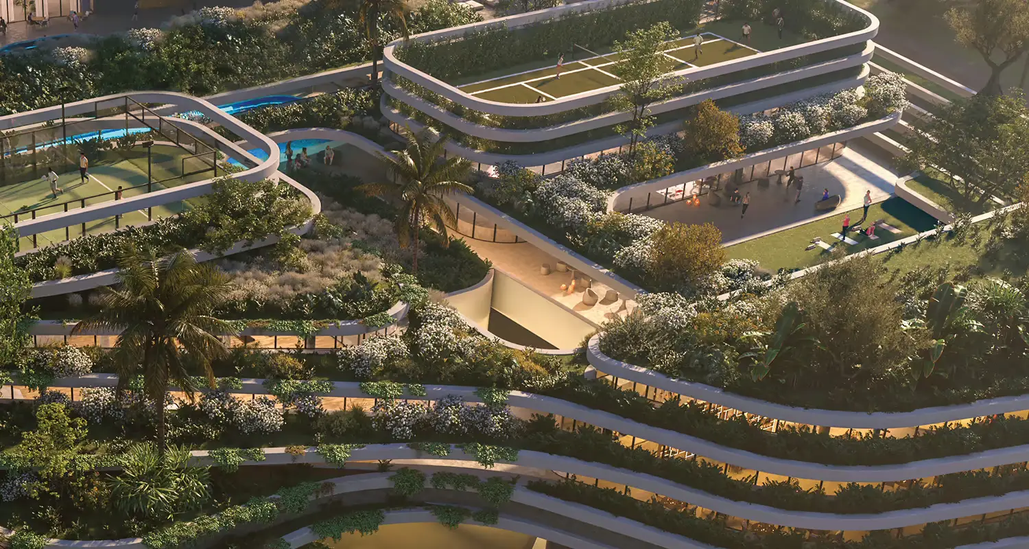 Aerial view of a multi-level building with greenery, pools, and recreational areas.