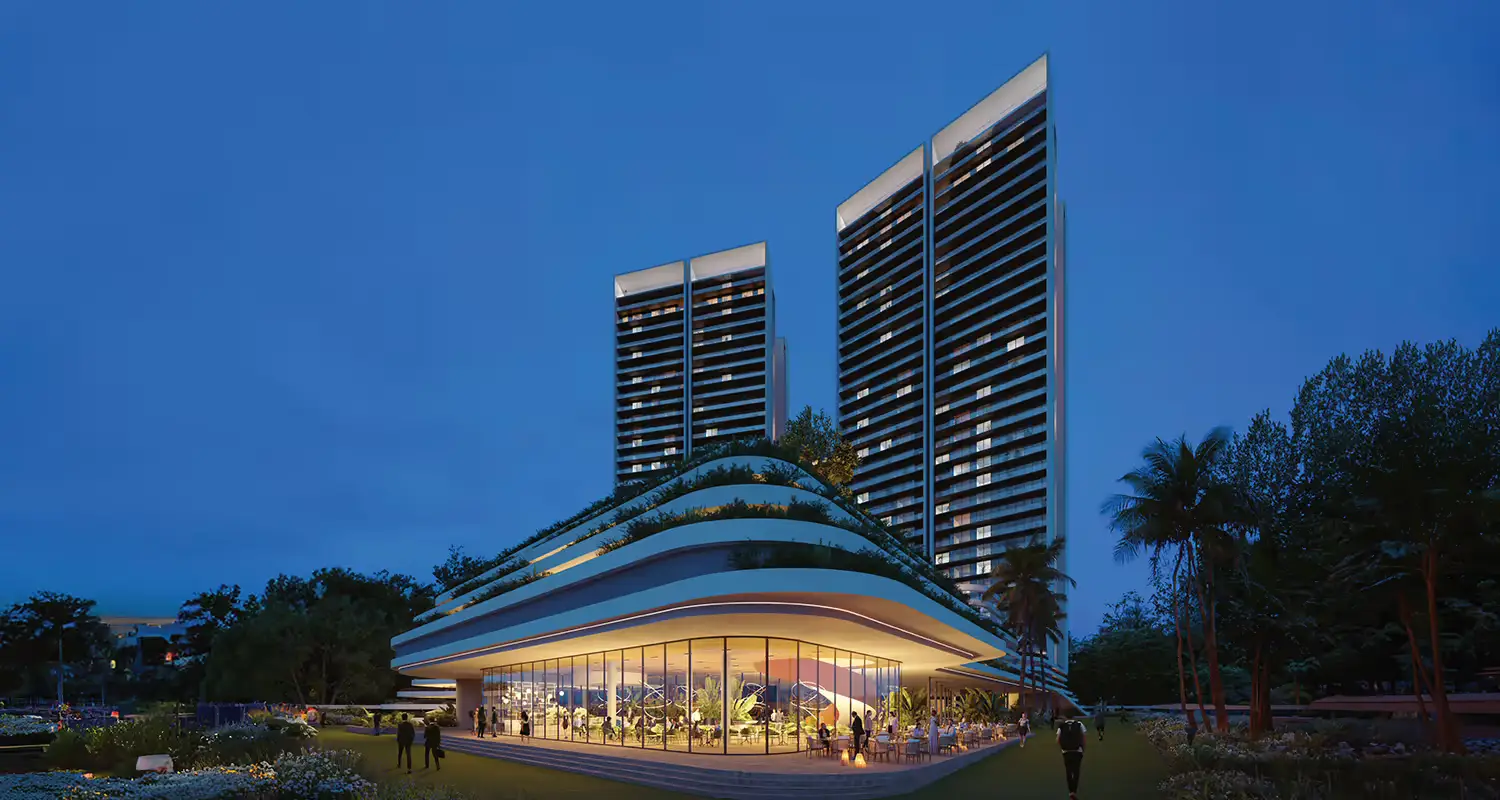 Two tall residential buildings beside a curved, glass-fronted structure at dusk.