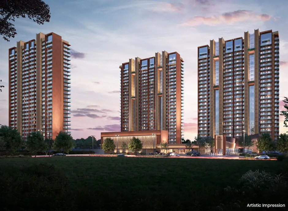 Four modern residential towers with glass facades and landscaped area under a twilight sky.