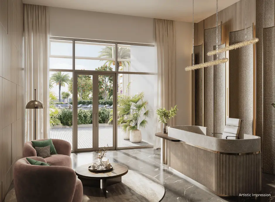 Spacious lobby with a reception desk, seating area, and large windows showing greenery outside.