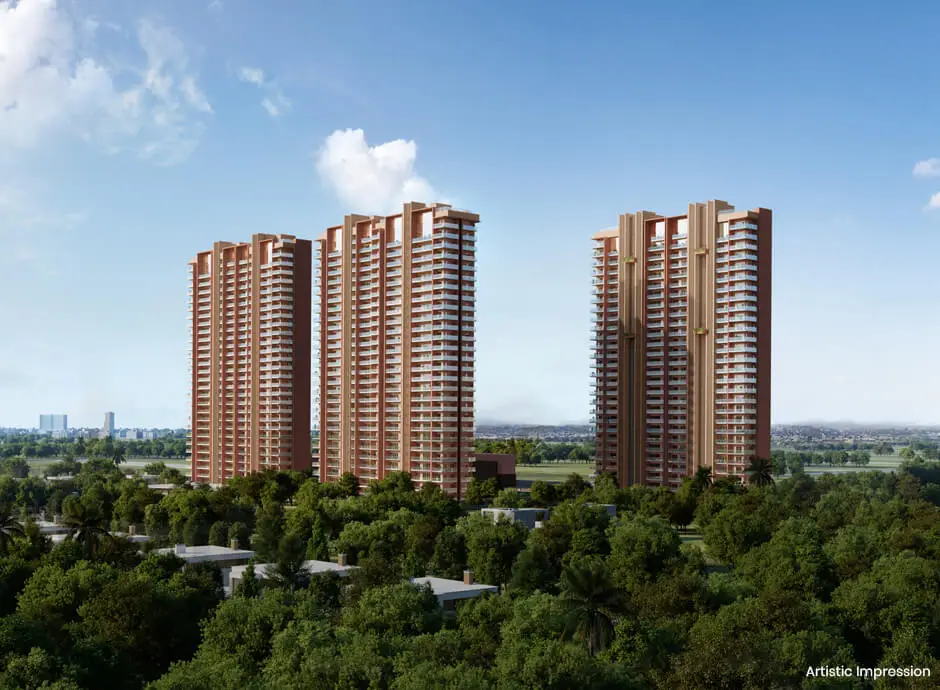 Three tall residential buildings surrounded by lush greenery and blue sky with clouds.