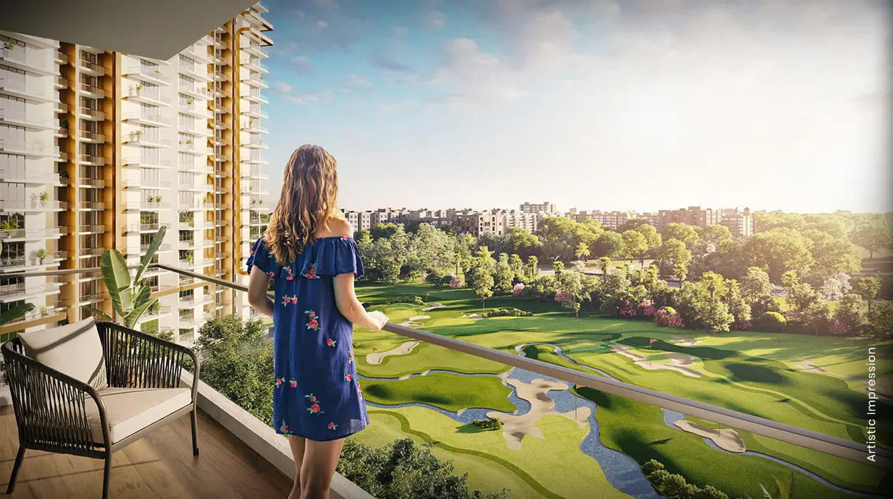 A woman in a blue dress stands on a balcony overlooking a green golf course and cityscape.