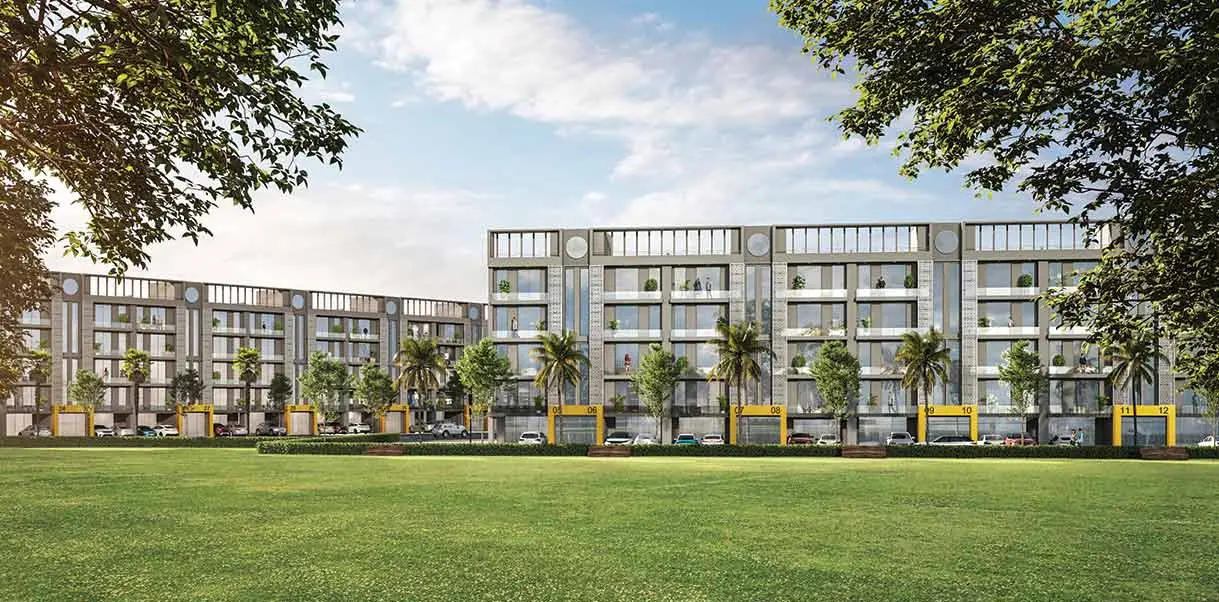 Modern residential building with multiple floors, palm trees, and green lawn in foreground.