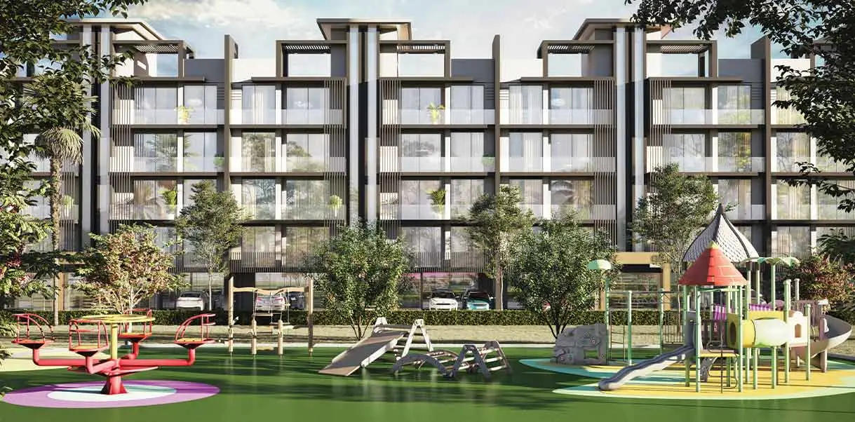 Modern playground with slides, swings, and climbing structures in front of residential buildings.