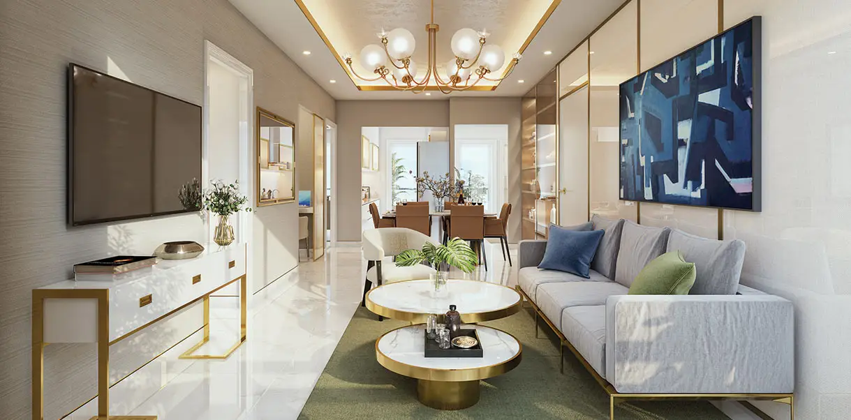 Bright living room featuring a white sofa, gold accents, and a large chandelier overhead.