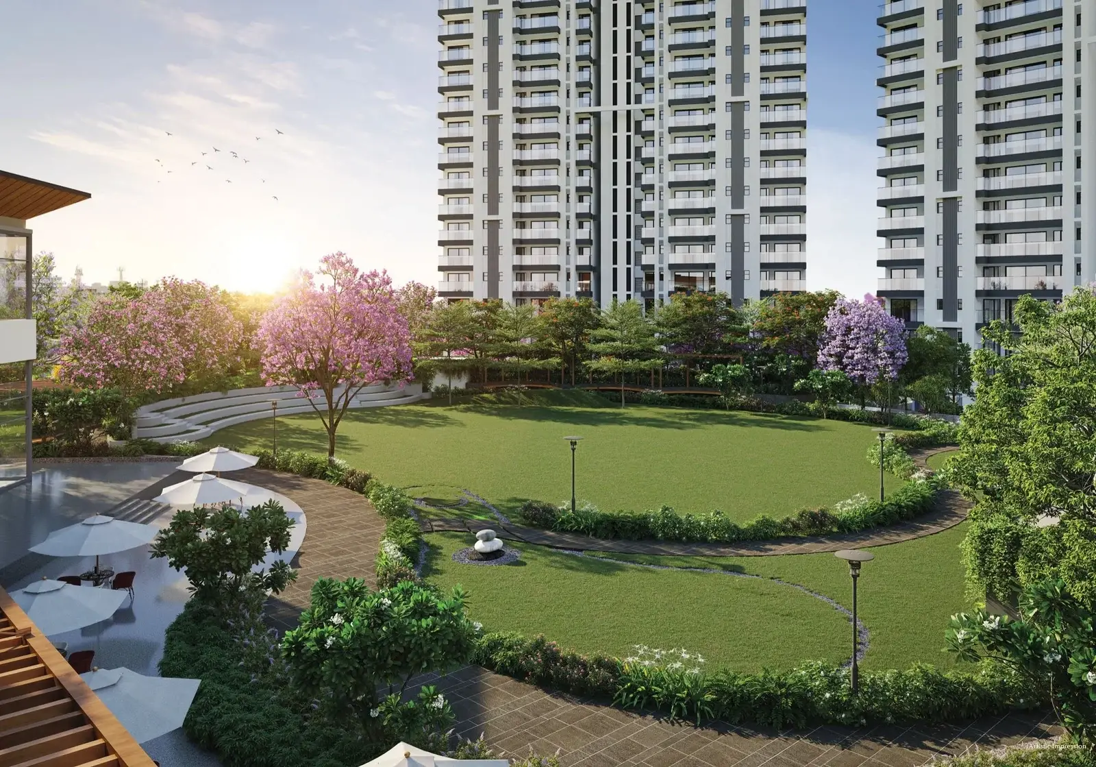 Modern residential buildings with green lawns and flowering trees in a landscaped garden.