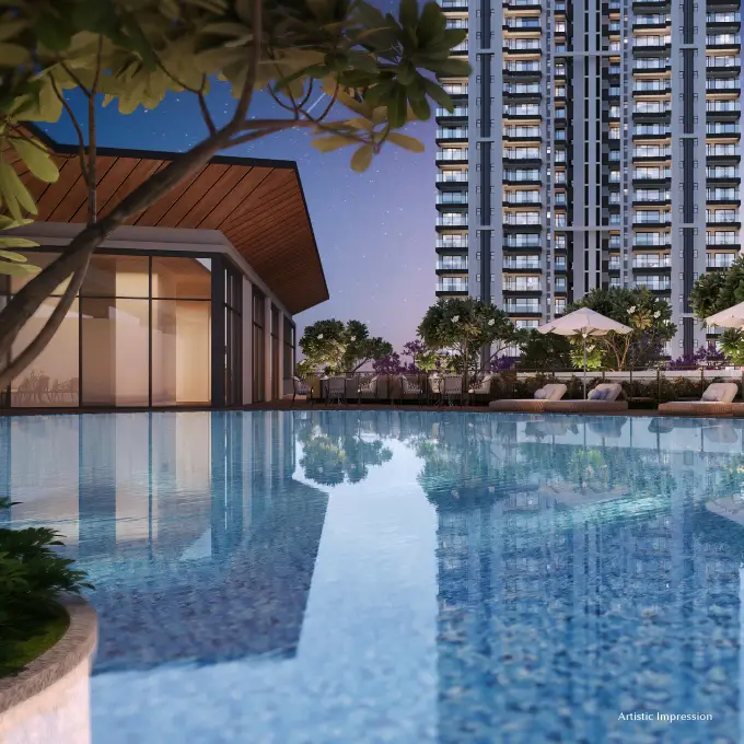 Serene pool reflecting a modern building with lounge chairs and greenery at dusk.