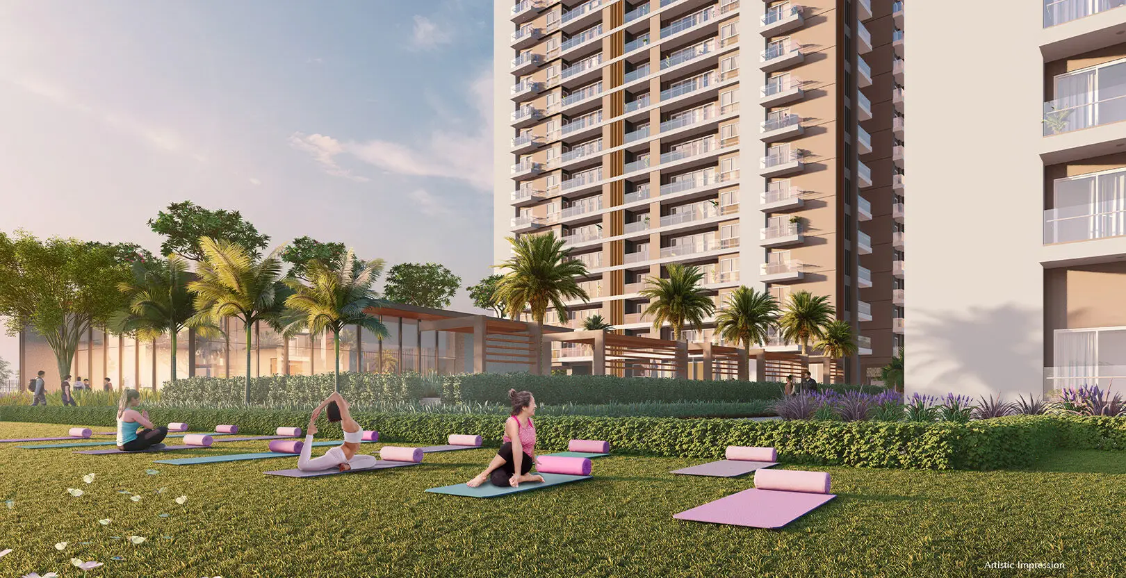 People practicing yoga on mats in a landscaped area with palm trees and a building backdrop.