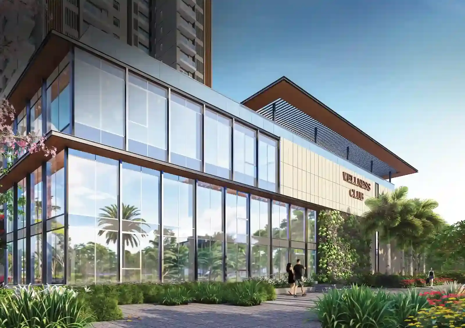 Modern building with large glass windows, greenery, and two people walking towards entrance.