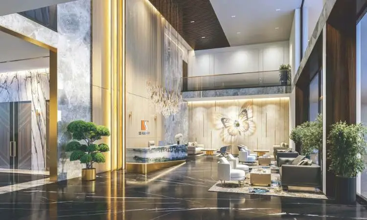 Spacious lobby with marble walls, elegant seating, and decorative plants, featuring a butterfly artwork.