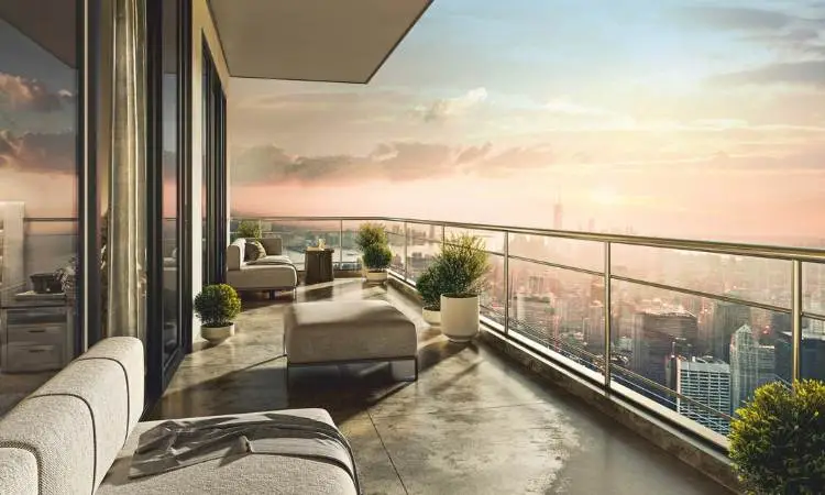 Modern balcony with lounge chairs, potted plants, and a city skyline at sunset.