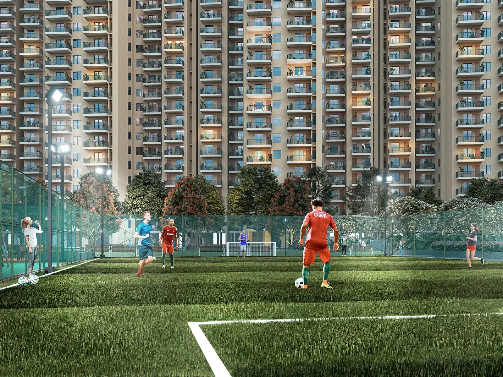 Players in colorful jerseys playing soccer on a green field with residential buildings in the background.