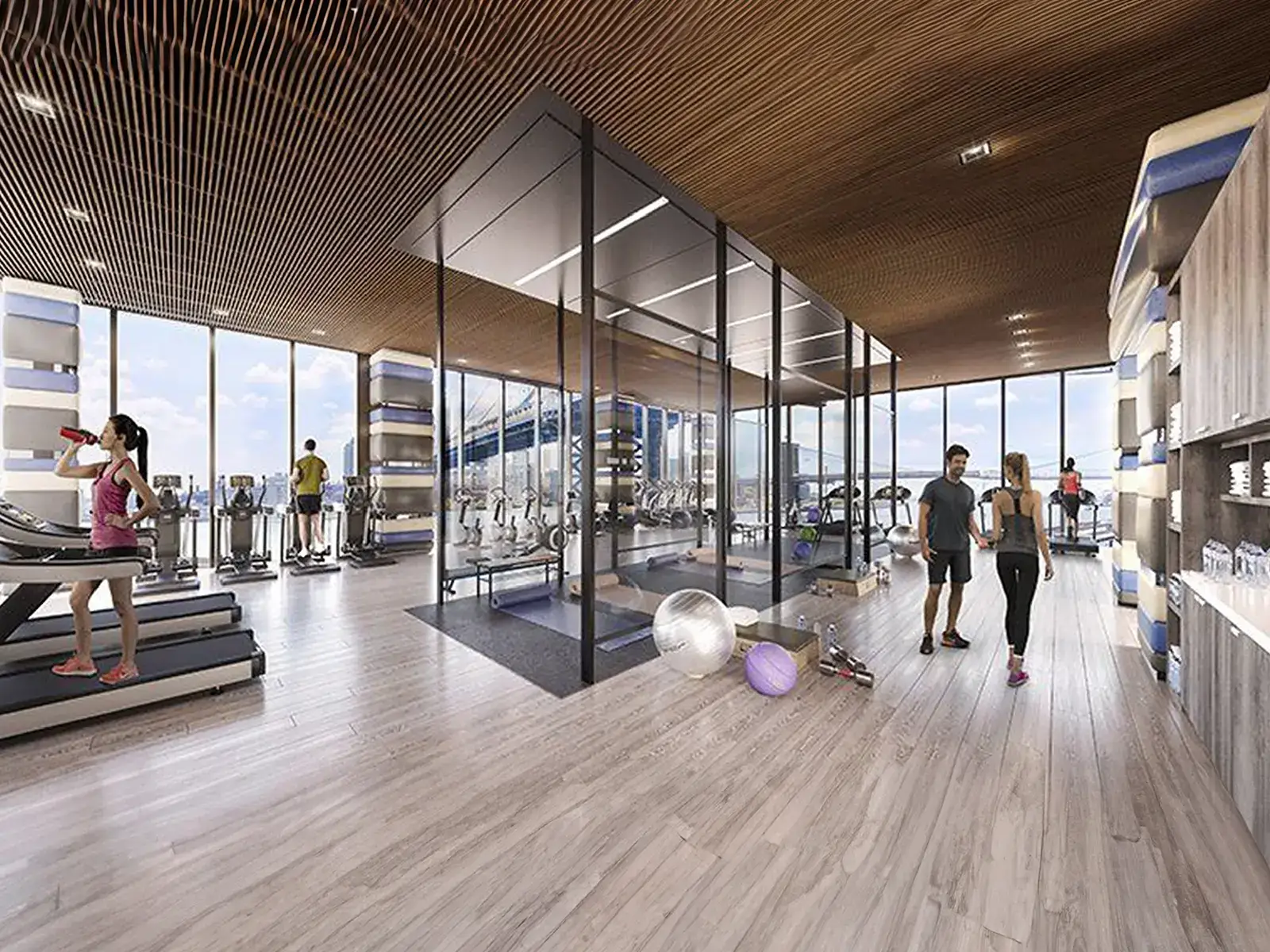 Modern gym interior with exercise equipment, large windows, and people using treadmills.