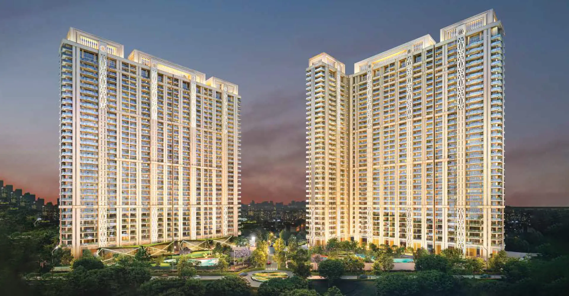 Two tall residential towers with balconies and landscaped gardens at dusk.